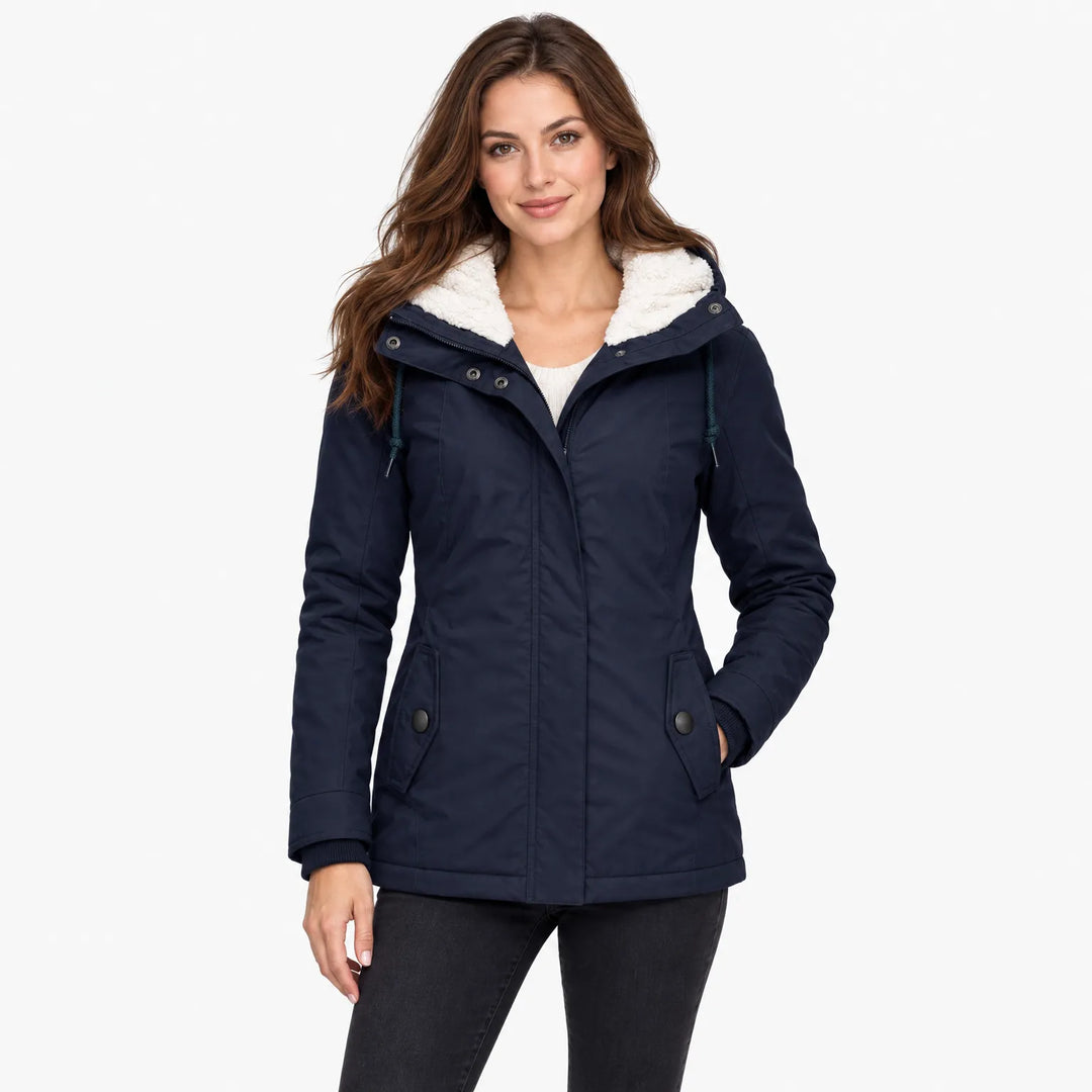 Brunette woman wears the navy jacket open over a cream sweater and black jeans, hand in pocket 12