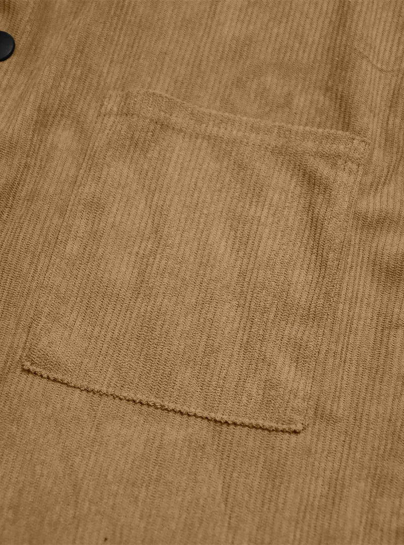 Close-up of a patch chest pocket on the tan ribbed shirt, with edge stitching 12
