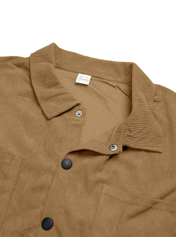 Collar and neckline detail of the tan shirt with metal snaps and a sewn-in size label 13