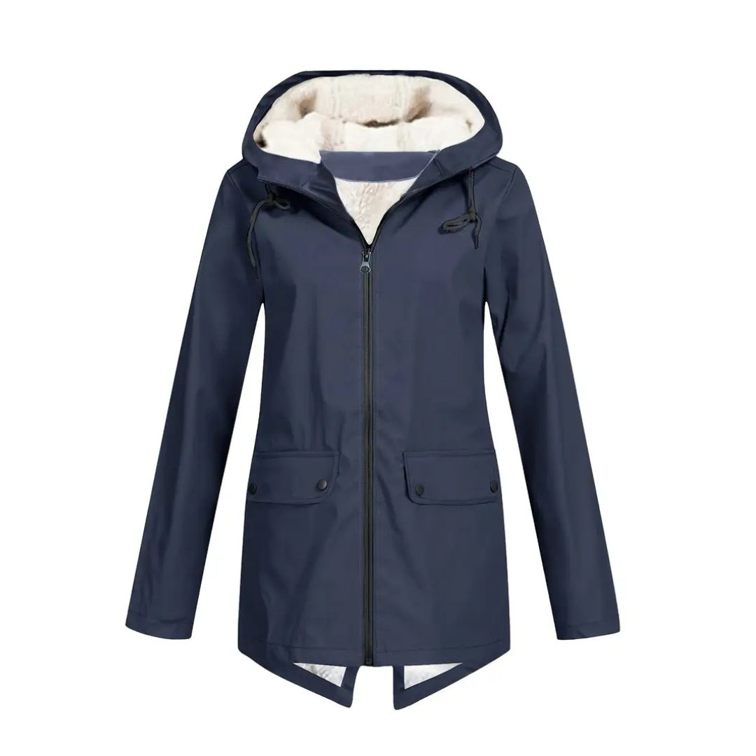 Flat lay detail of the navy blue version of the jacket with cream fleece-lined hood, black zipper and flap pockets.