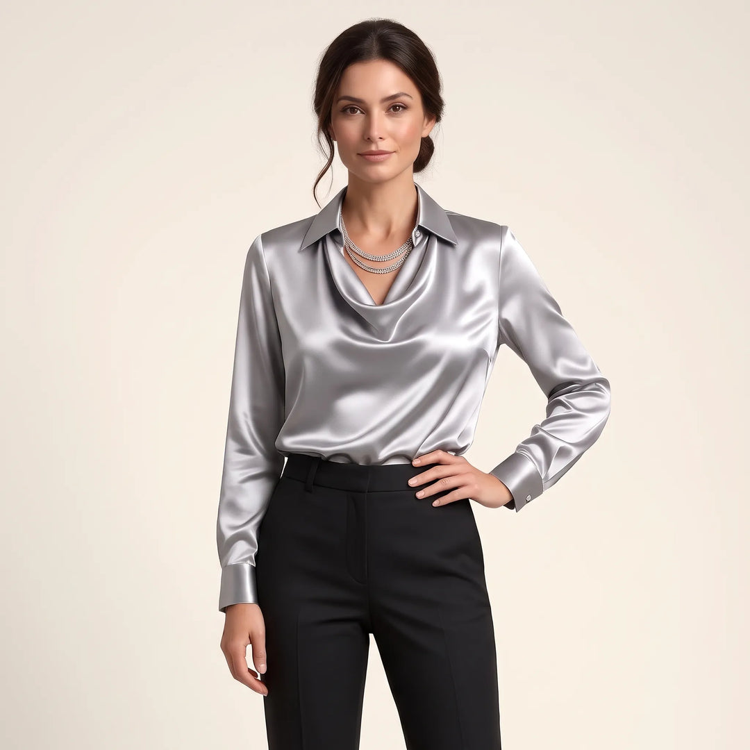 Studio view of the shiny silver-gray satin blouse with layered necklace and black trousers 13