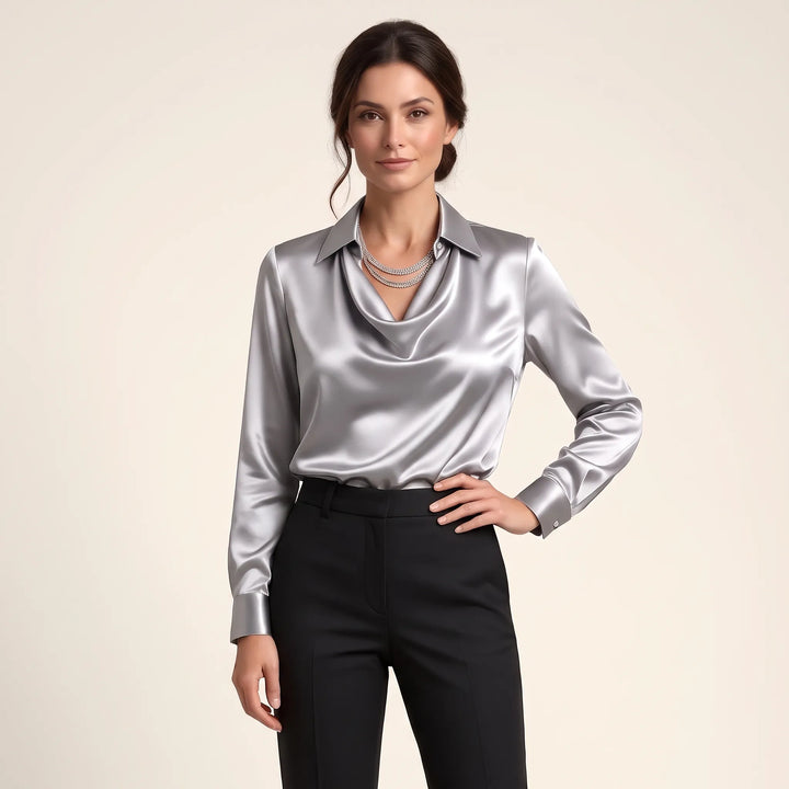 Studio view of the shiny silver-gray satin blouse with layered necklace and black trousers 13