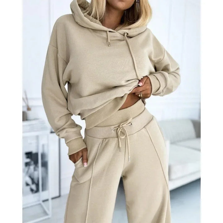 Torso close-up of a beige hoodie with drawstrings and matching ribbed-waist pants with front seam 13