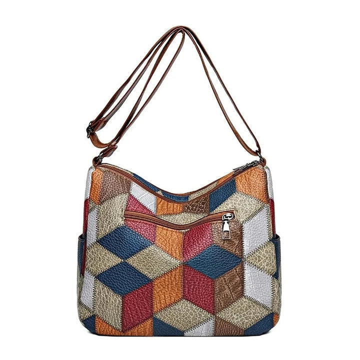 Back view of the patchwork bag showing a diamond-pattern panel in blue, red, orange and tan with one zip pocket. 10
