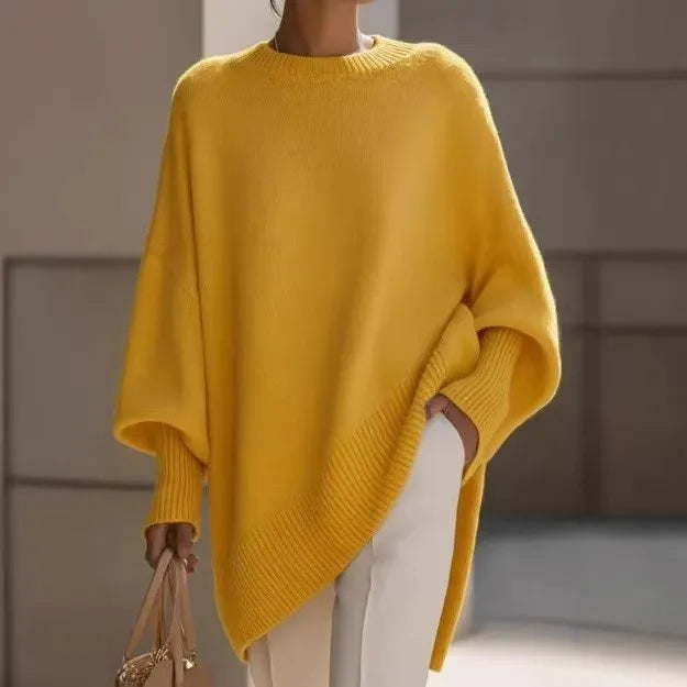 Yellow loose knit sweater with ribbed cuffs and asymmetric hem, styled with white pants and a handbag 13