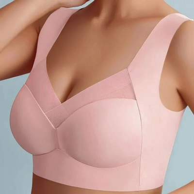 Model wearing a pink seamless bra with wide straps and a mesh trim at the neckline 15