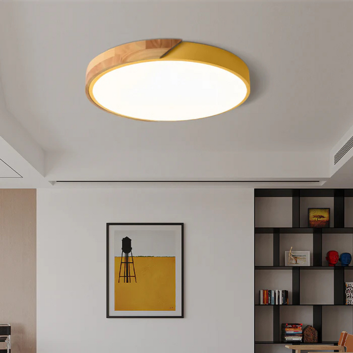Delos Scandi Wood Ceiling Light in yellow and wood trim in a living room.