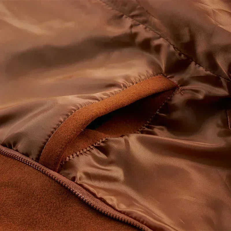 Close-up of the satin-like brown lining and an inner pocket opening next to the zipper 13