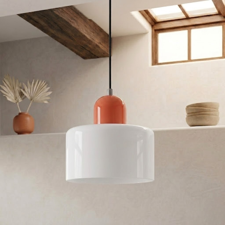 Glossy white drum shade with an orange-red rounded cap, hanging from a black cord beside a terracotta vase. 19