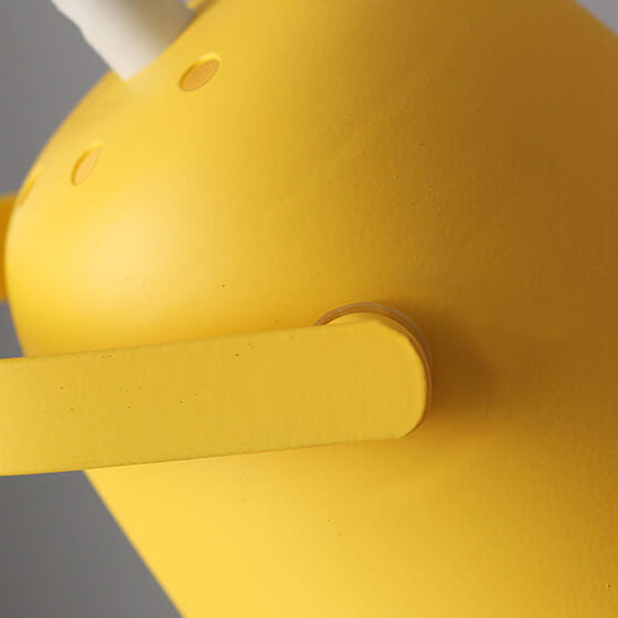Detail of the matte yellow shade's pivot arm and small ventilation holes near the cord 3