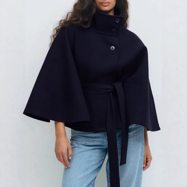 Navy cape jacket close view of the buttoned high collar and belt with long hanging tails 14