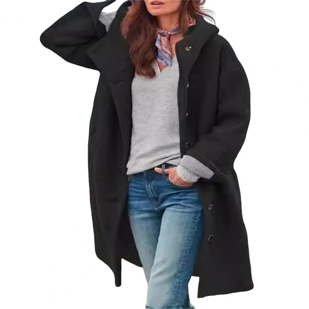Black hooded coat with scarf, gray top and jeans, photographed on a plain white background 14