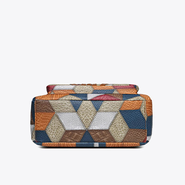 Bottom of the bag showing a hexagon and triangle patchwork pattern in blue, orange, brown and light gray tones. 12