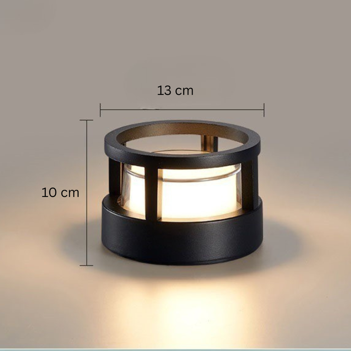 Round open-ring-top black lamp with dimension lines marking its width and height, shown glowing against a beige backdrop. 13