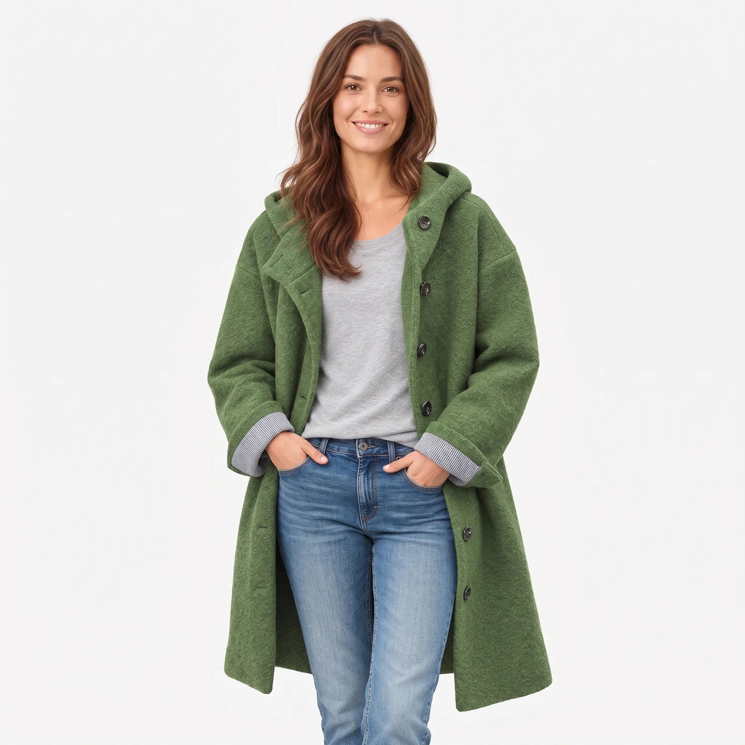 Full-length studio view of the green hooded coat worn open, hands in jeans pockets 15