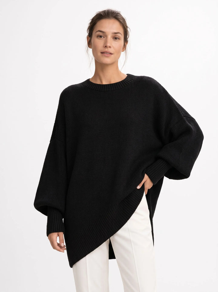 Studio shot of black oversized knit sweater with ribbed neckline, balloon sleeves and high-low hem 15