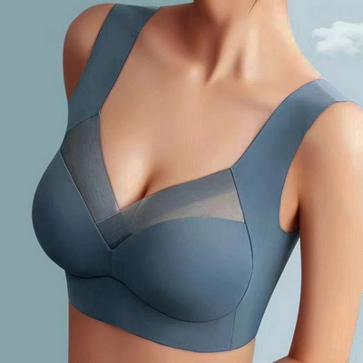 Model wearing a slate blue seamless bra with a sheer mesh V-neck panel 1