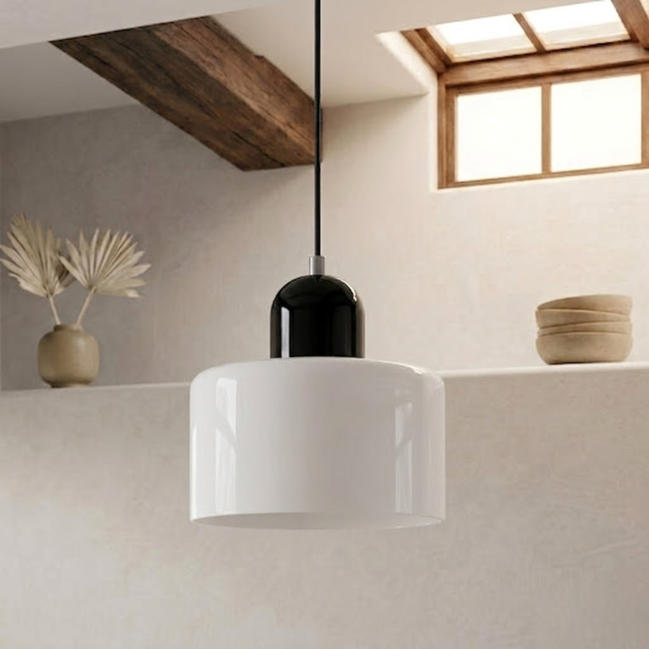 Glossy white drum shade with a black dome cap hangs on a black cord beside a wood beam and skylight. 22