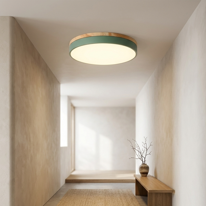 Green round ceiling light with wood trim lit warm in a narrow hallway with a wooden bench and woven runner. 7
