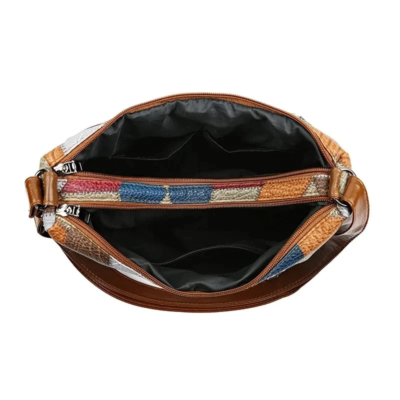 Top-down view into the open bag showing a dark lining and the zippered compartments with patchwork edges. 13