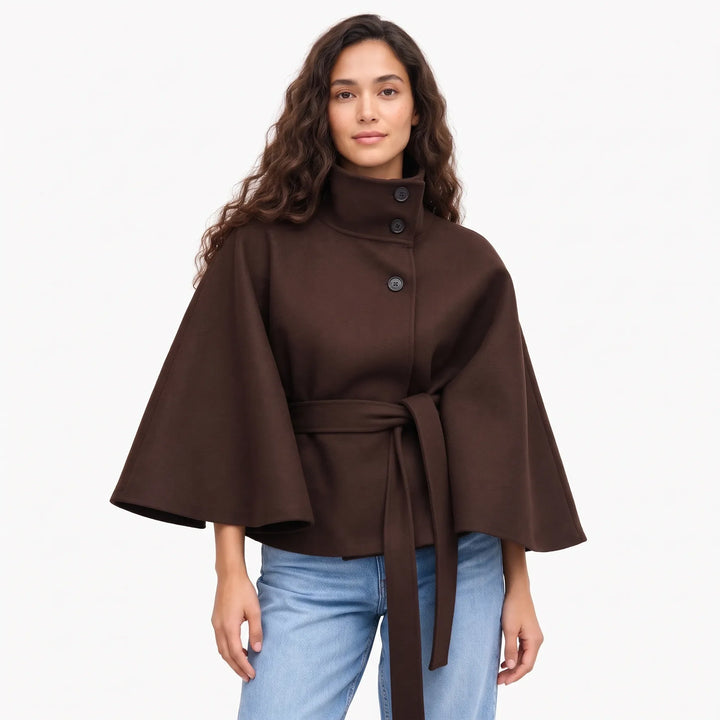 Studio shot of a model in the dark brown cape jacket with buttoned collar and belt 16