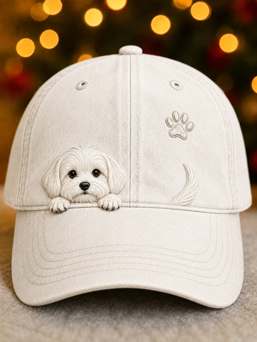Washed off-white baseball cap with a raised white puppy peeking over the brim, a paw print and a tail.