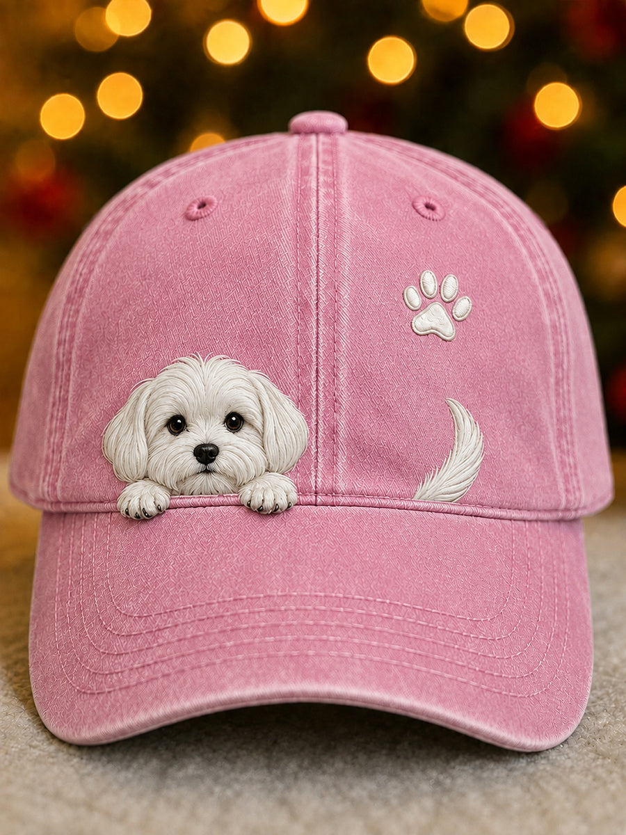 Washed pink baseball cap with a raised white puppy peeking over the brim, a paw print and a tail.