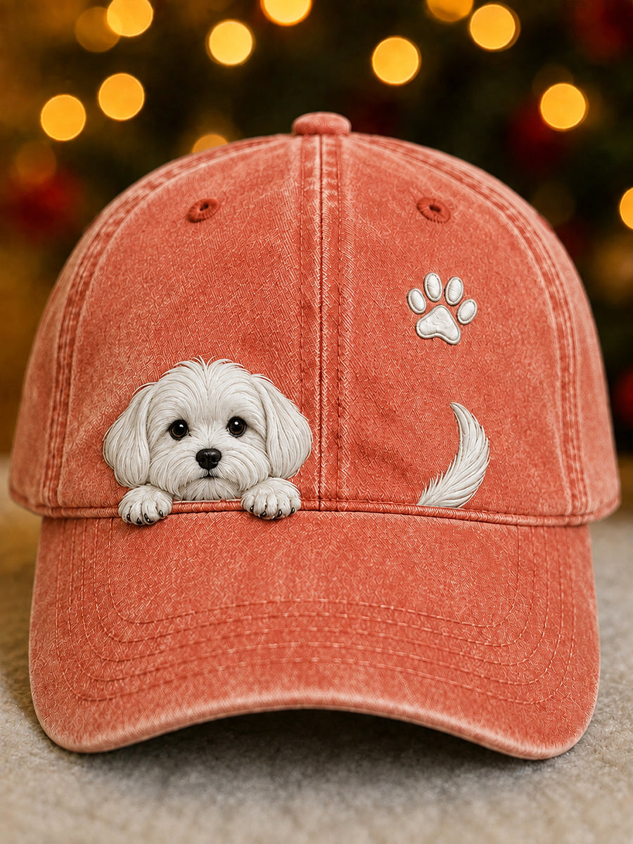 Washed coral orange baseball cap with a raised white puppy peeking over the brim, a paw print and a tail.