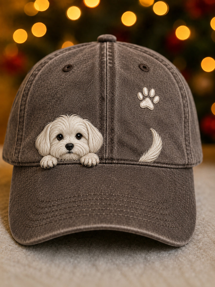 Washed brown baseball cap with a raised white puppy peeking over the brim, a paw print and a tail.