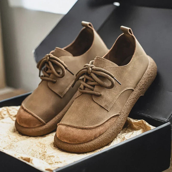 Khaki lace-up shoes with suede toe caps displayed in an open gift box 17