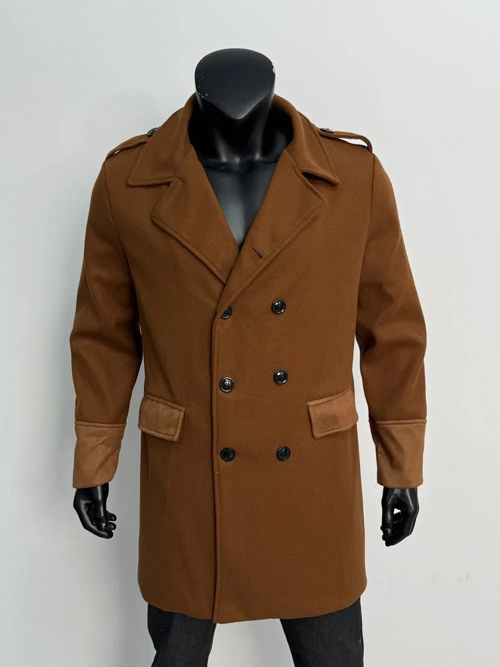 Caramel brown double-breasted coat on a mannequin, front view with black buttons and suede-look flaps and cuffs 17