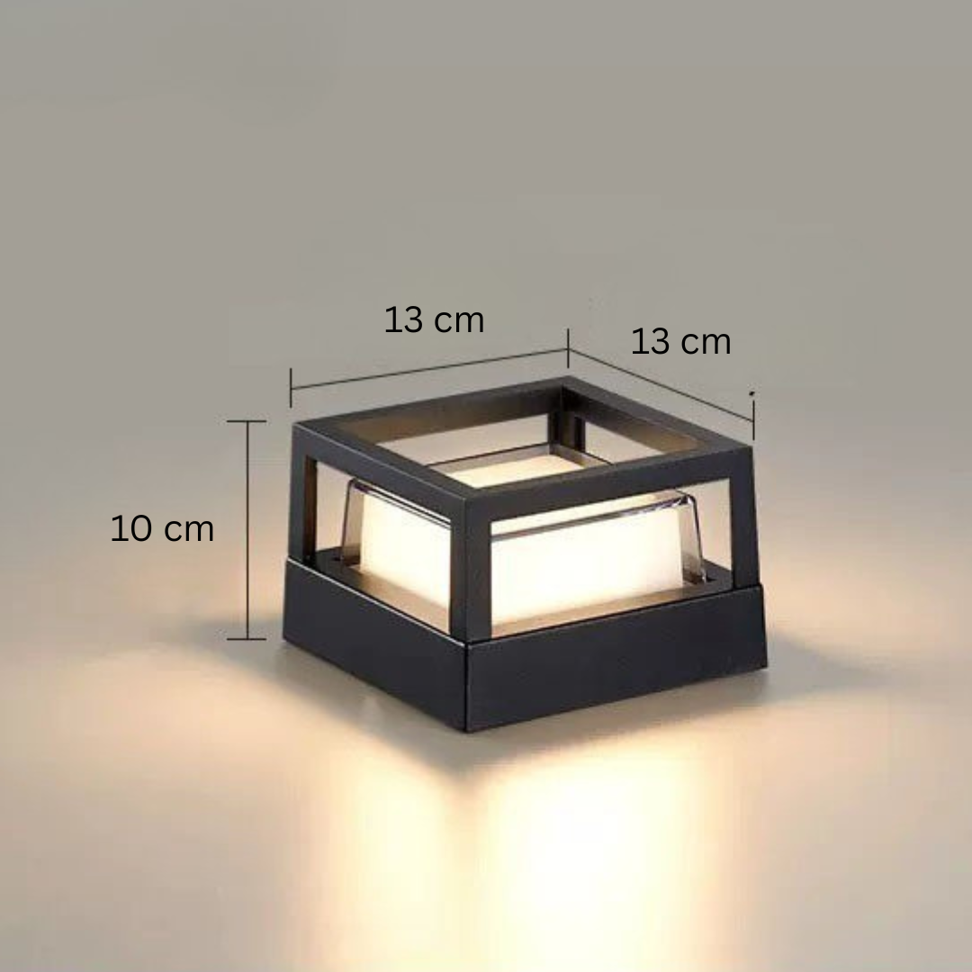 Square open-frame black lamp with dimension lines marking width, depth and height, glowing on a neutral backdrop. 15