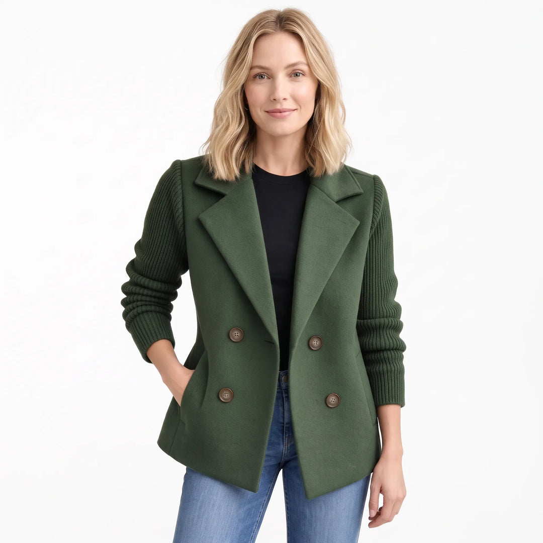 Model wearing dark green jacket with ribbed sleeves, one hand in pocket, over black top and jeans 17
