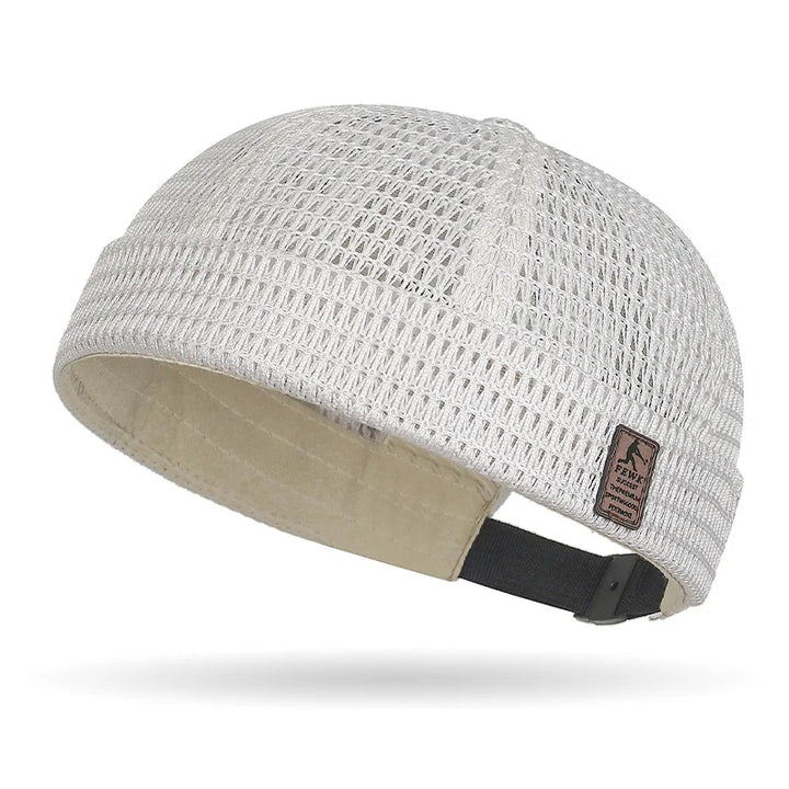 Off-white open weave brimless cap with beige lining, leather patch and black rear strap 17