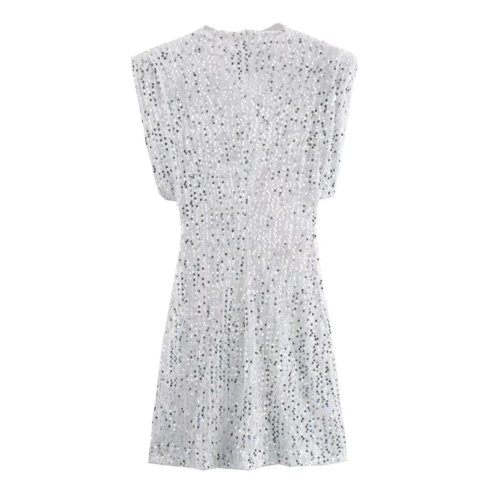 Back view of white sequined mini dress laid flat, showing seamed waist 17