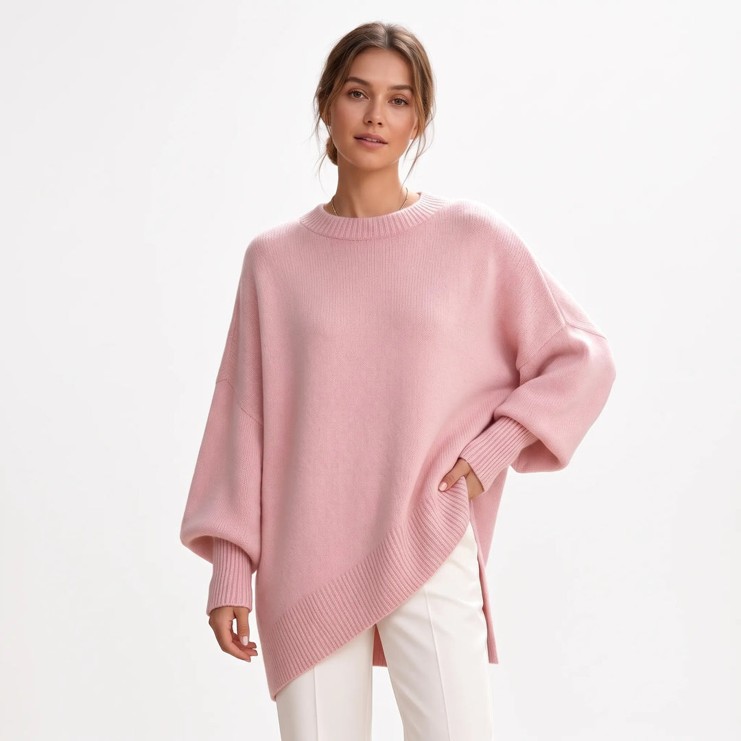 Studio shot of pink loose knit sweater with ribbed hem and balloon sleeves, white trousers 17