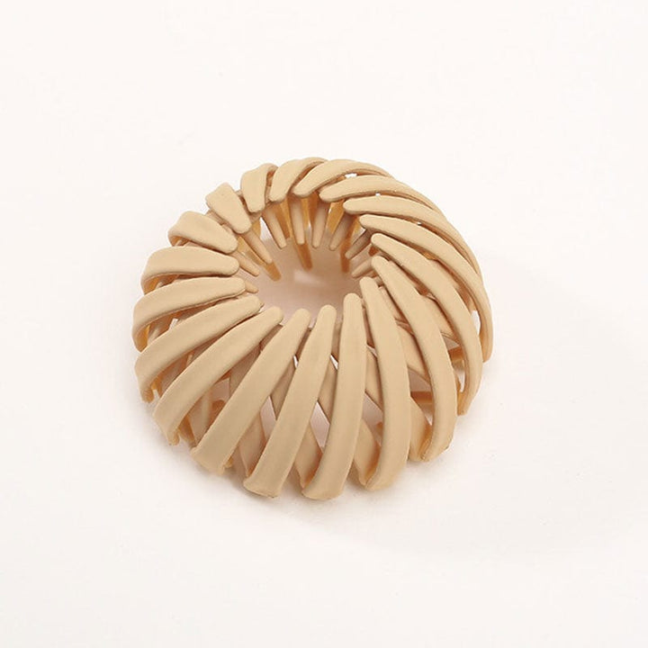Twist-and-snap hair clip in sand beige velvet shown from above.