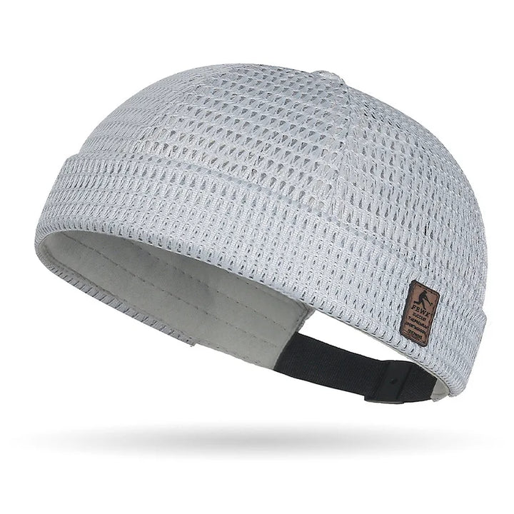 Light gray open weave brimless cap with leather patch and black adjustable rear strap 18