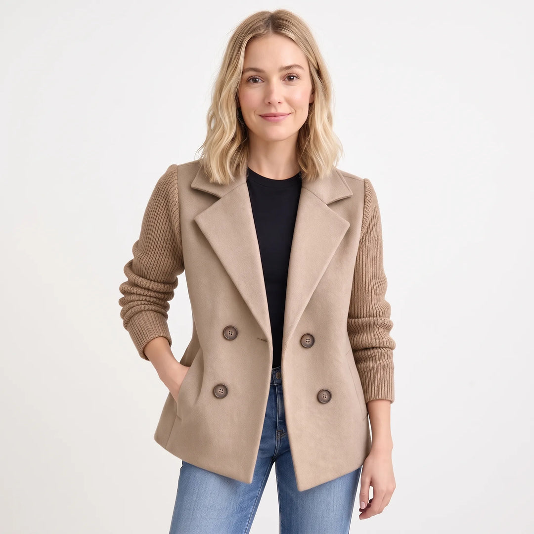 Model wearing camel-beige jacket with ribbed knit sleeves, hand in pocket, with black top and jeans 18