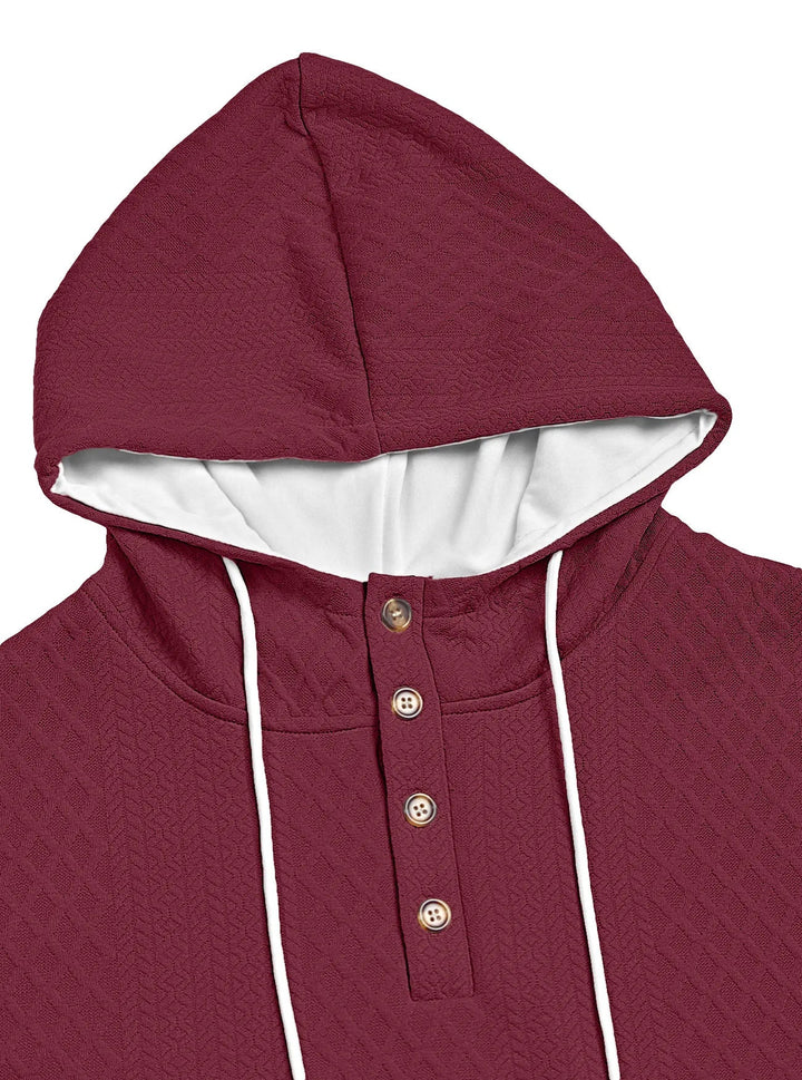 Close-up of a burgundy hoodie's hood and four-button placket with white drawstrings and textured knit 18