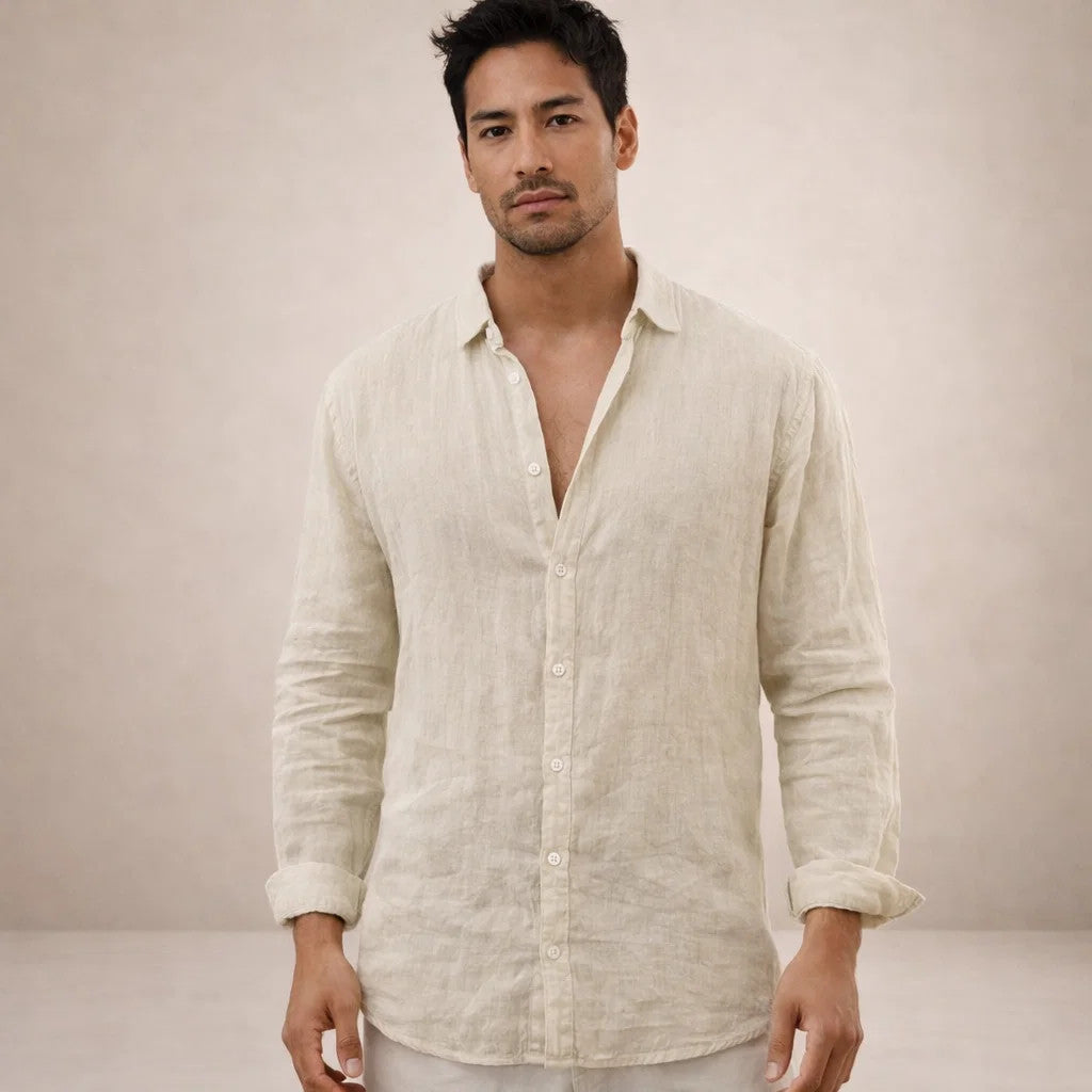 Model in the cream-beige linen shirt, slightly textured and wrinkled, sleeves rolled to the forearms.