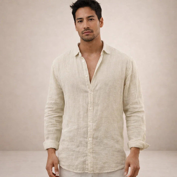 Model in the cream-beige linen shirt, slightly textured and wrinkled, sleeves rolled to the forearms.