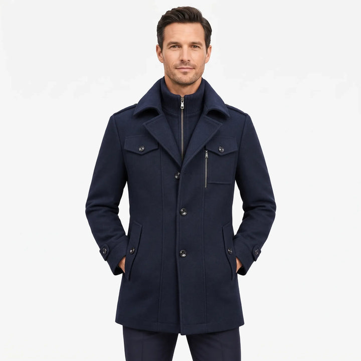 Man facing the camera in the navy overcoat, hands in pockets, showing the layered knit collar 19