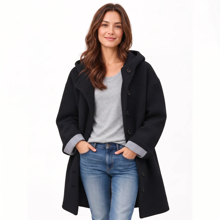 Studio shot of the black hooded coat with striped rolled cuffs, hands in jeans pockets 19