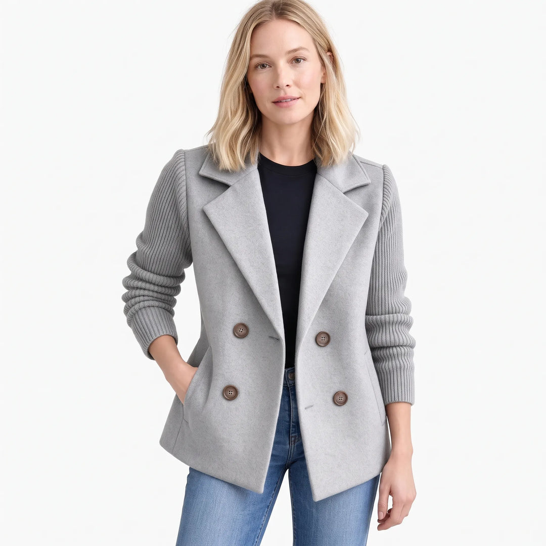 Model wearing light gray jacket with ribbed sleeves and brown buttons, hand in pocket, with jeans 19