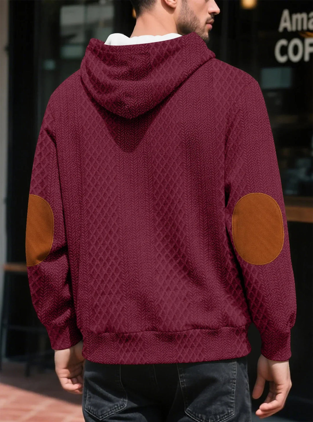 Back view of a man in a burgundy textured hoodie showing large brown elbow patches and ribbed hem 19