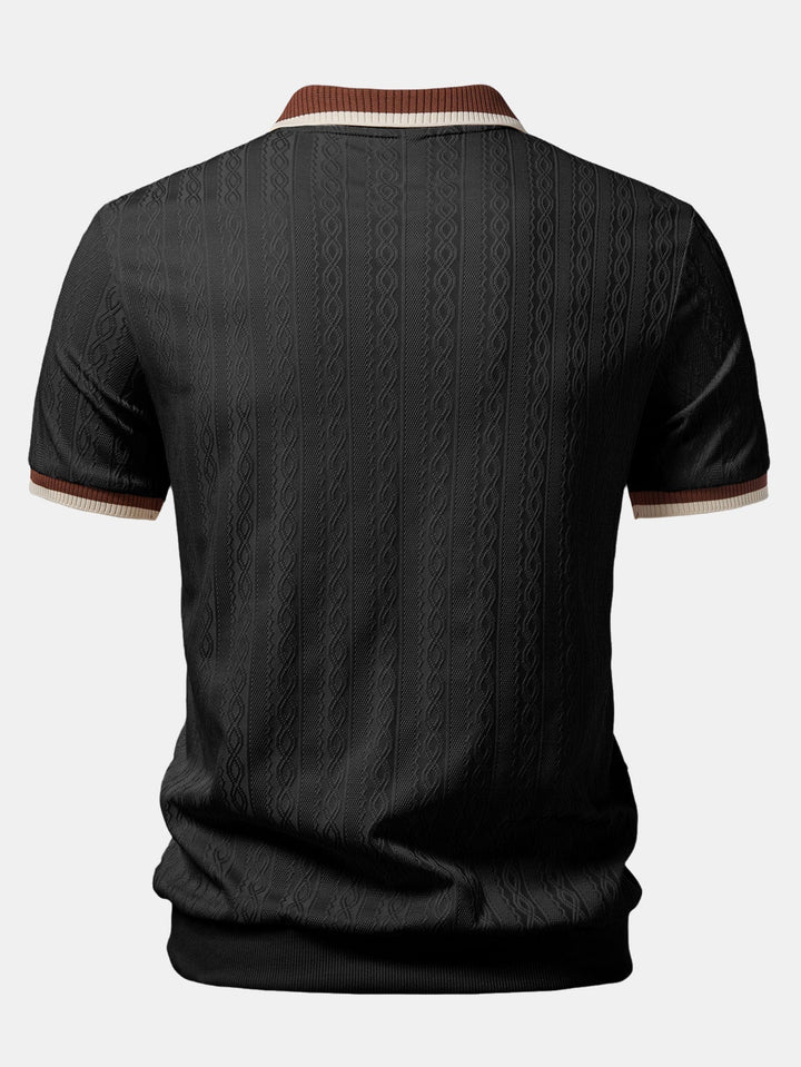 Black textured knit polo from the back with the tonal cable pattern, striped collar edge, sleeve cuffs, and ribbed hem.