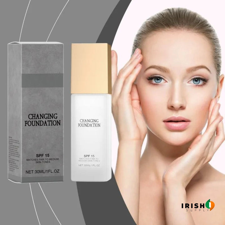 Gray carton and frosted bottle with gold cap beside a model with a slicked-back bun touching her face.