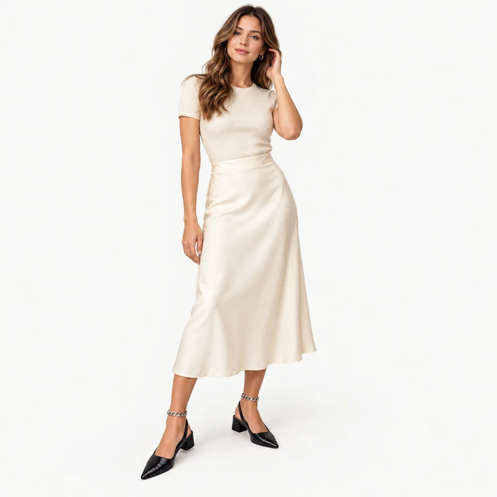 Model in black croc-embossed slingback block heels with a chain anklet, styled with a cream satin midi skirt 1