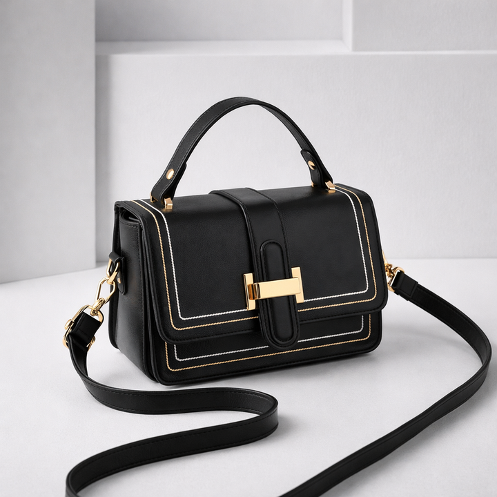 Black version with gold hardware and white and gold stitching, angled studio view with the long strap curled in front. 5